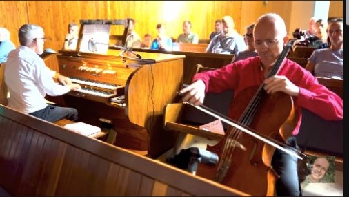 Jacco Viljoen playing the cello with organist Johan van der Watt during a live performance